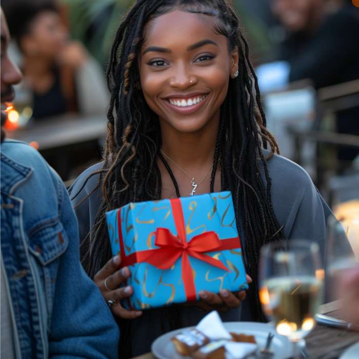 Smiling woman holding a beautifully wrapped birthday gift, perfect for 'Birthday Gifts For Her South Africa