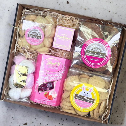 Birthday Treats for Her Gift Box with biscuits, Lindt chocolates, marshmallows, and more, beautifully packed in a straw-filled box.