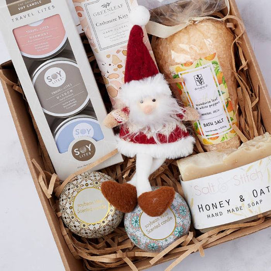 Close-up of the Christmas Silver Snow Gift Box featuring luxury candles, bath essentials, and a Santa doll for the holidays.