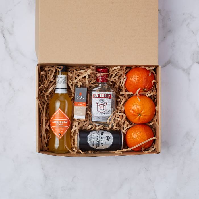 Clementine Citrus Bliss Box with ClemenGold soda, vodka, soda water, essential oil, and fresh clementines in a gift package.