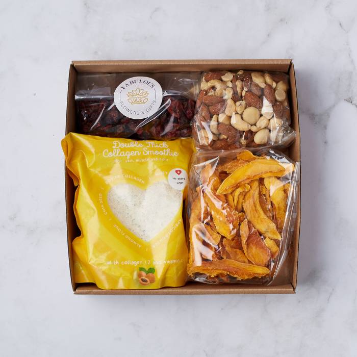 Fabulous Wellness Delight Snack Gift Box featuring a collagen smoothie mix, dried mango slices, nut medley, and cranberries, beautifully arranged in a brown gift box.