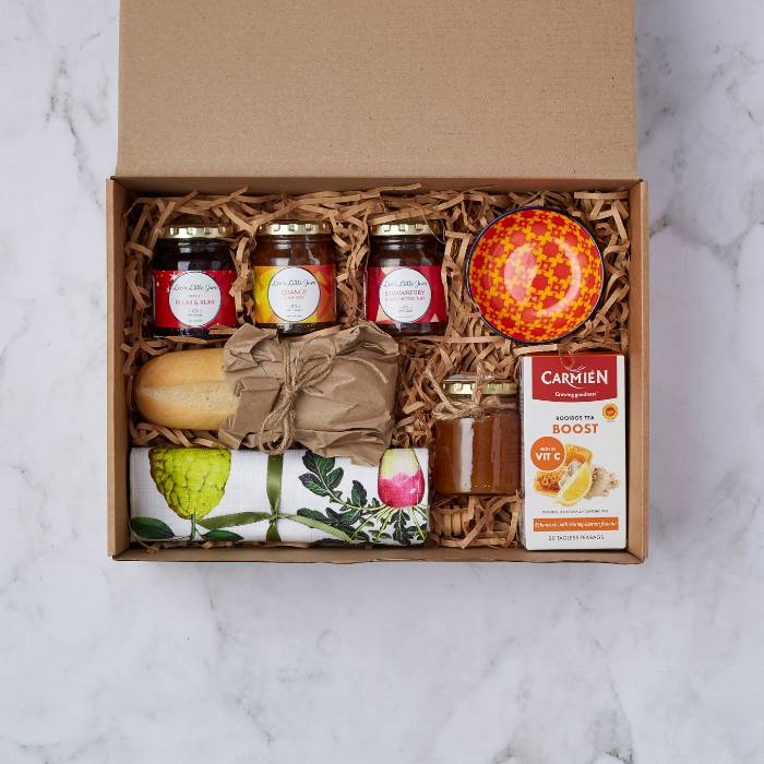 Family Breakfast Gift Box featuring artisan preserves, raw honey, artisan bread, tea towel, and Carmién rooibos tea.