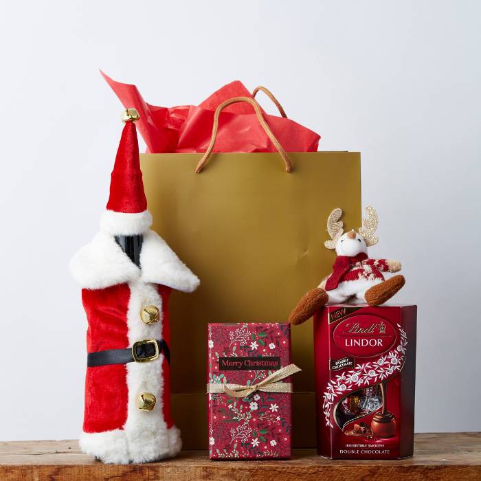 Fancy Festive Christmas Gift Box with Lindt chocolates, Santa wine bottle cover, gold gift bag, and Christmas decor.