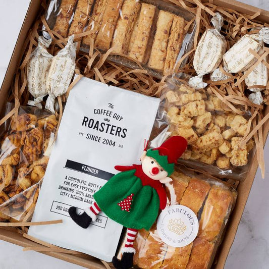 Festive Coffee Delight Gift Box featuring premium Coffee Guy Roasters coffee, rusks, nougat, and an elf figurine, beautifully packaged.