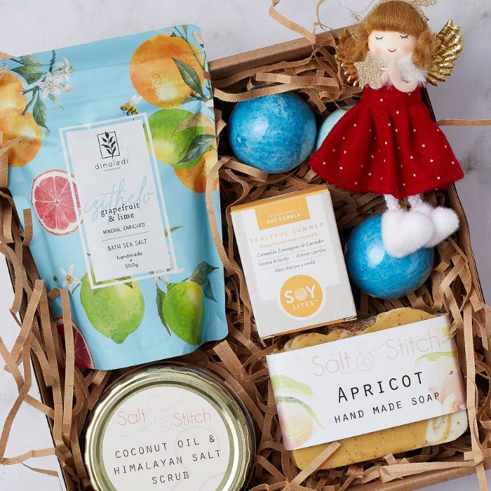 Festive Glow Spa Gift Set featuring Grapefruit & Lime Bath Sea Salt, Soy Lites candle, Salt & Stitch scrub, soap, and festive angel decoration.