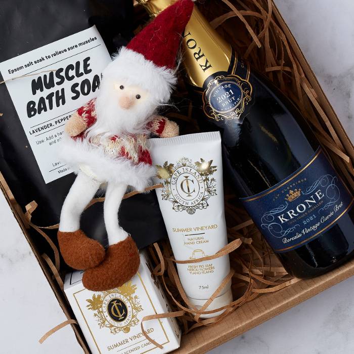 Festive Luxe Celebration Gift Box featuring Krone Brut MCC, Muscle Bath Soak, Cape Island hand cream and candle, and a festive Santa ornament.