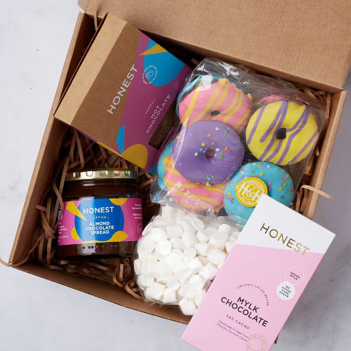 Close-up of Choco Bliss & Sweet Treats gift box showcasing colourful cookies, a bar of pink mylk chocolate, almond chocolate spread jar, marshmallows, and hot chocolate mix, perfect for indulgent gifting.