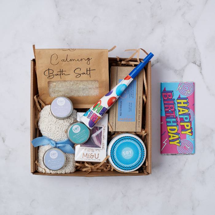 Birthday Treats & Tranquility Gift Box displayed with calming bath salts, mini travel candles, and birthday-themed items in eco-friendly packaging.