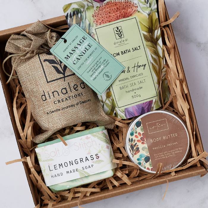 Blissful Indulgences gift box featuring lemongrass handmade soap, vanilla velvet body butter, massage candle, and bath sea salts beautifully arranged in eco-friendly packaging.