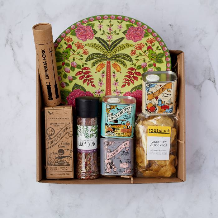 Get Cookin’ Goodlookin’ Gift Box with spices, firelighters, chilli oil, potato chips, and artisan serving platter.