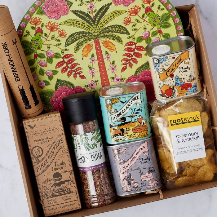 Close-up of Get Cookin’ Goodlookin’ Gift Box featuring African BBQ spice, Funky Ouma salt, and decorative platter.