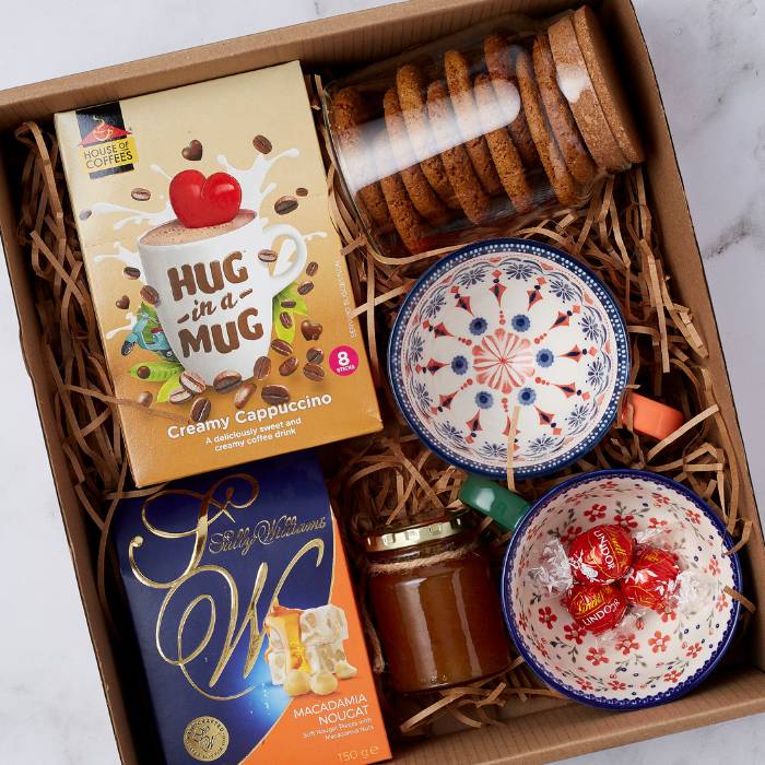 Close-up of Honey I’m Home Gift Box featuring Lindt chocolates, handcrafted bowls, biscuits, and pure honey.