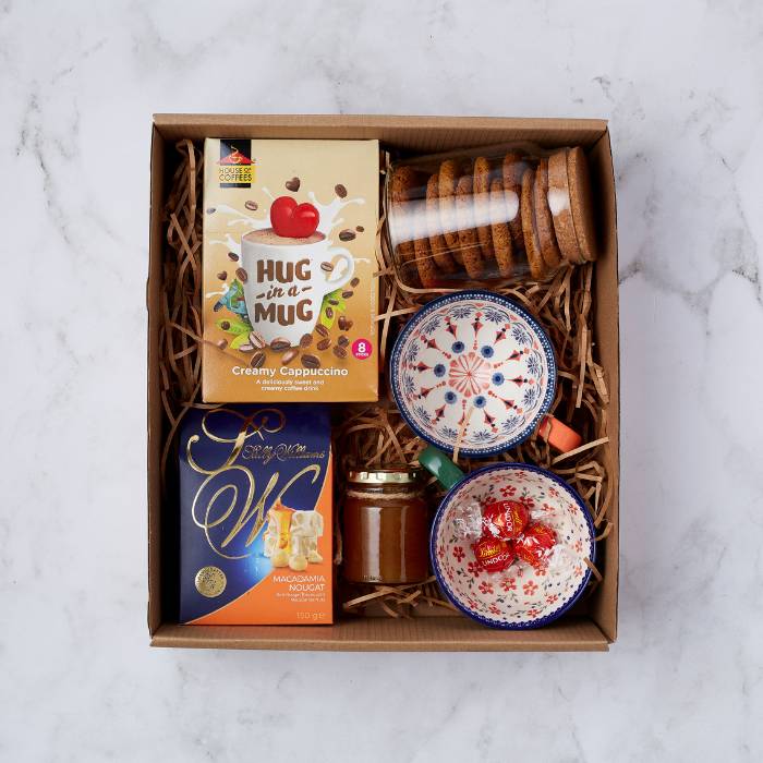 Honey I’m Home Gift Box with Hug in a Mug cappuccino, Sally Williams nougat, biscuits, honey, and ceramic bowls.