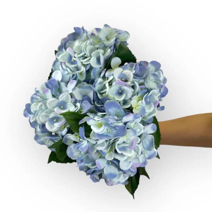 A bouquet of Hydrangea Medium Blue Artificial Flowers held in hand, showcasing lush and realistic blue blooms