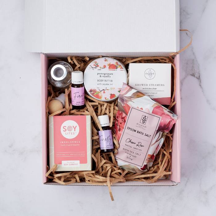 It’s Me Time gift box featuring Soy Lites candle, bath salts, body butter, essential oils, shower steamers, and more.