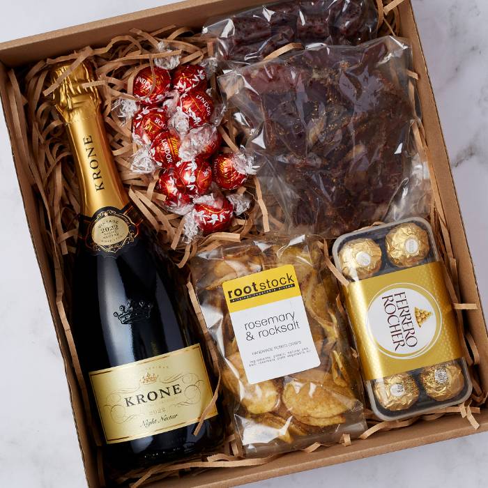 Close-up view of the Krone & Crisp Exquisite Snack Hamper displaying a premium bottle of Krone MCC, gourmet snacks, and chocolates arranged elegantly in a gift box.

Close-up view of the Krone & Crisp Exquisite Snack Hamper displaying a premium bottle of Krone MCC, gourmet snacks, and chocolates arranged elegantly in a gift box.


