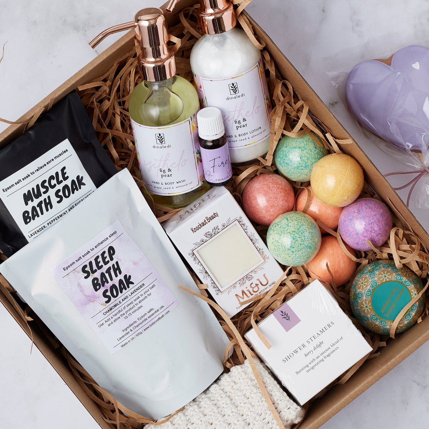 Close-up of Lady of Leisure Hamper featuring knitted cloth, lavender soap, and vibrant bath bombs.