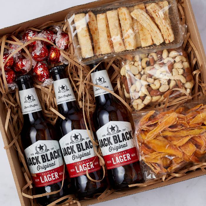 Close-up of Lager & Snack Gift Box with craft beer, snacks, and chocolates for gifting.