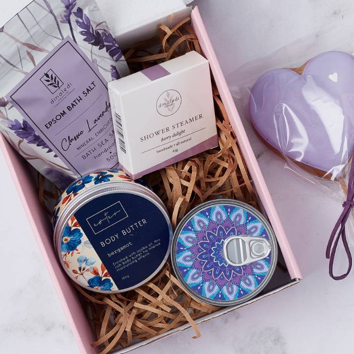 Close-up of Lavender Bliss Gift Box featuring bath salts, shower steamer, mandala candle, and heart-shaped cookie.