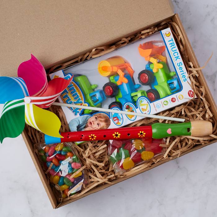 Close-up of Little Builders Fun Kit featuring colourful toys and sweet treats for kids.