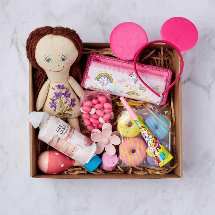 Little Princess Gift Box with doll, unicorn pencil case, candies, bath bombs, and headband.