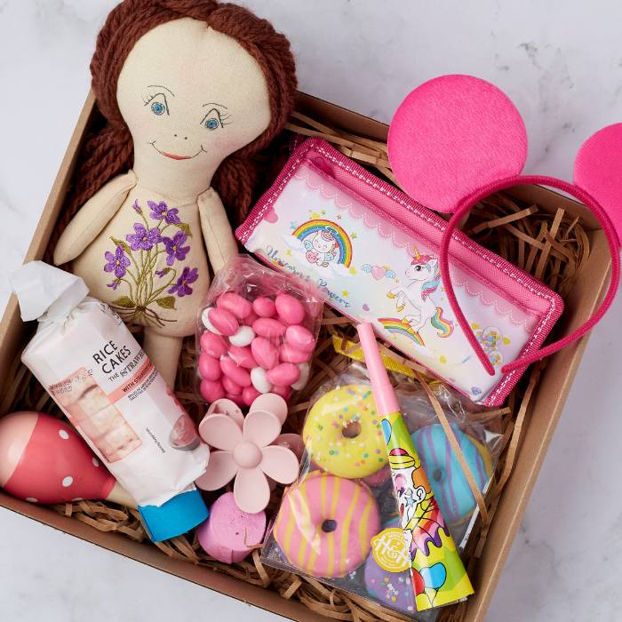 Close-up of Little Princess Gift Box featuring handcrafted doll, unicorn pencil case, and colourful bath bombs.