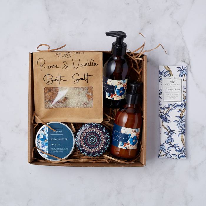 Opulent Oasis Gift Box featuring rose and vanilla bath salt, magnolia body butter, luxury hand wash and lotion, and classic linen sachet.