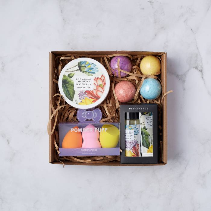 Pamper and Glow Gift Box featuring botanical body butter, bath bombs, makeup sponges, and luxurious hand cream set.