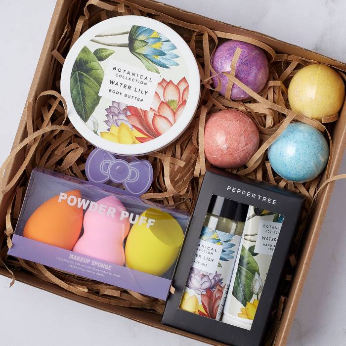 Beautifully arranged Pamper and Glow Gift Box with premium self-care items including body butter, bath bombs, and hand cream.