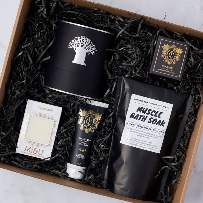 Top-down view of the Recharge Pamper Gift Box, showcasing its luxurious self-care products and elegant black packaging.