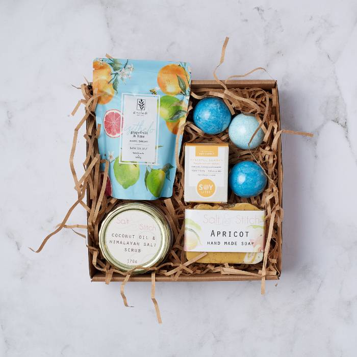 Relax and Unwind Gift Box by Flower Guy featuring bath salts, soy candle, bath bombs, handmade soap, and coconut oil salt scrub.