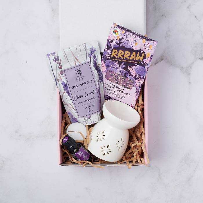 Serenity Spa Gift Box featuring lavender bath salt, white chocolate, essential oil, ceramic oil burner, and tealight candle.