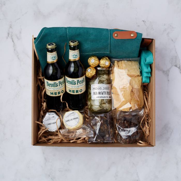 Tasting Adventure Gift Box featuring non-alcoholic beer, gourmet cheese, crackers, and snacks beautifully packaged.