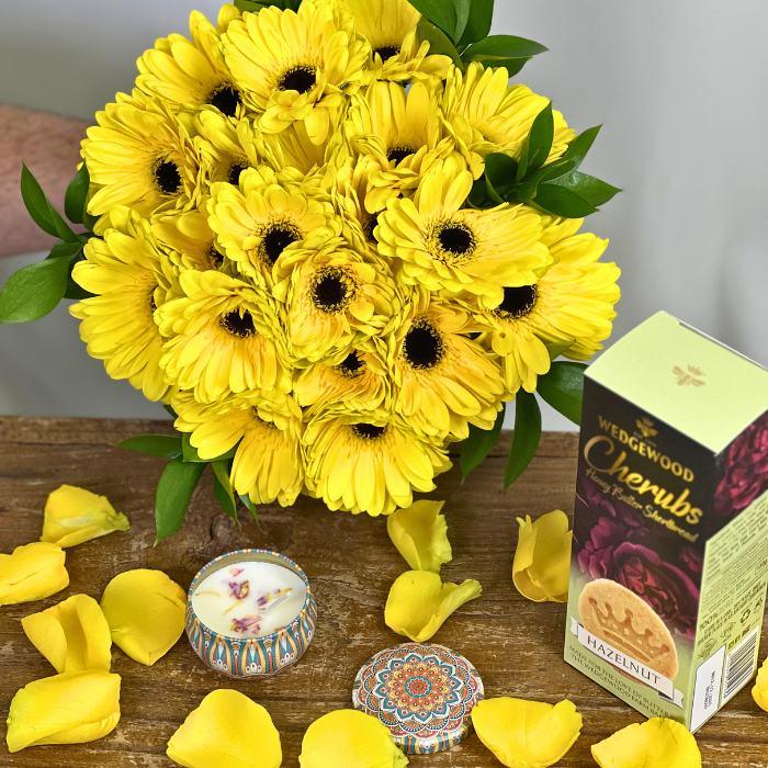 Wedgewood Cherubs Hazelnut Shortbread and Fragrant Candle Option with vibrant yellow gerberas - Flower Guy